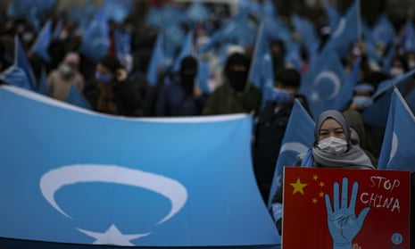 A woman from the Uyghur community in Turkey holds an anti-China placard during a protest in Istanbul in March