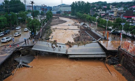 CHINA-WEATHER-FLOODThis aerial photo taken on July 21, 2021 show a damaged bridge following heavy rains which caused severe flooding in Gongyi in China’s central Henan province. (Photo by STR / AFP) / China OUT (Photo by STR/AFP via Getty Images)
