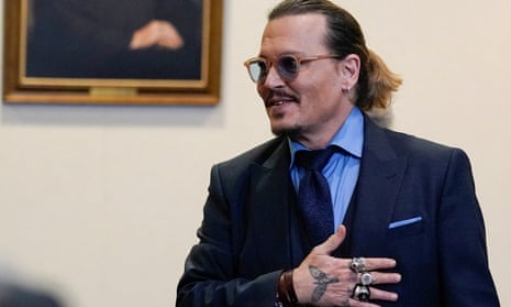 Johnny Depp gestures to spectators in court after closing arguments during the defamation in May