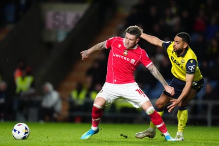 Wrexham's Josh Windass tries to get away from Oxford's Brodie Spencer.