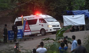 An ambulance leaves the cave area as the first boys are evacuated