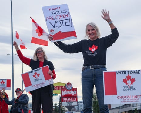 Forever Canadian supporters wave flags and hold signs urging people to vote in Calgary