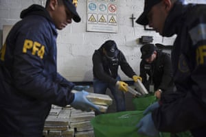 Police officers sort through illegal drugs in Buenos Aires on 10 May 2018.
