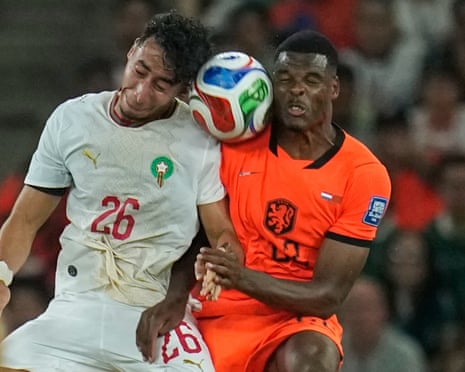 Morocco's Anass Salah Eddine (left) and Netherlands' Denzel Dumfries go up for a header.