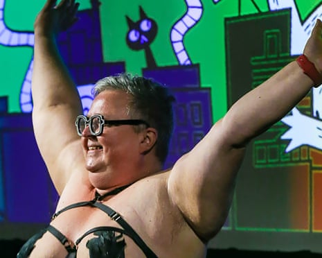 Kris Kneen with hands up while partially clothed