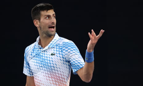 Novak Djokovic gestures to his bench