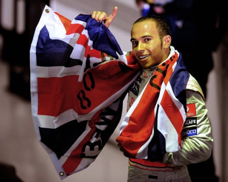 Lewis Hamilton waves with a union jack draped around his shoulders after winning the world championship at the Brazilian Grand Prix in 2008