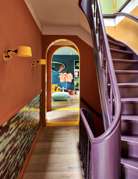 The orange hall and aubergine stairs.