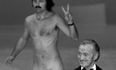 Oscar presenter David Niven isn't quite sure what's happening behind him as a streaker crosses the stage near the end of the 1974 Academy Awards show in Los Angeles, April 2, 1974. He later identified himself as Robert Opel. (AP Photo)