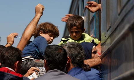 Migrants board a train