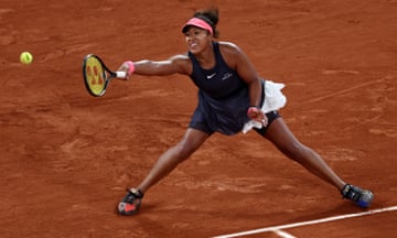 Naomi Osaka stretches for a forehand during her second round match against Iga Swiatek.