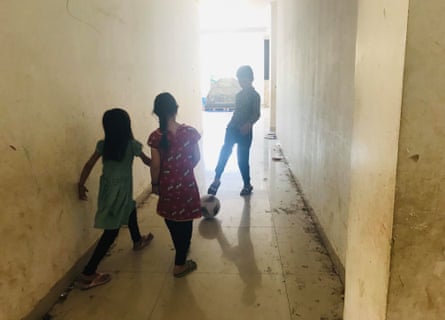 Hazara children playing football in the hallway of the former military building in Kalideres.