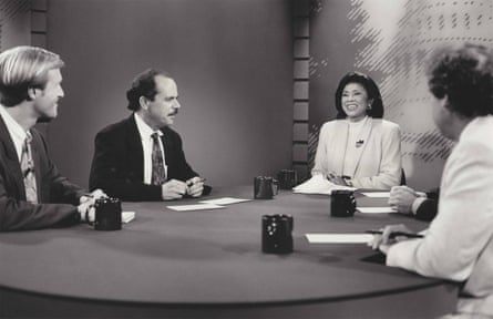a black and white photo of a group of people at a table