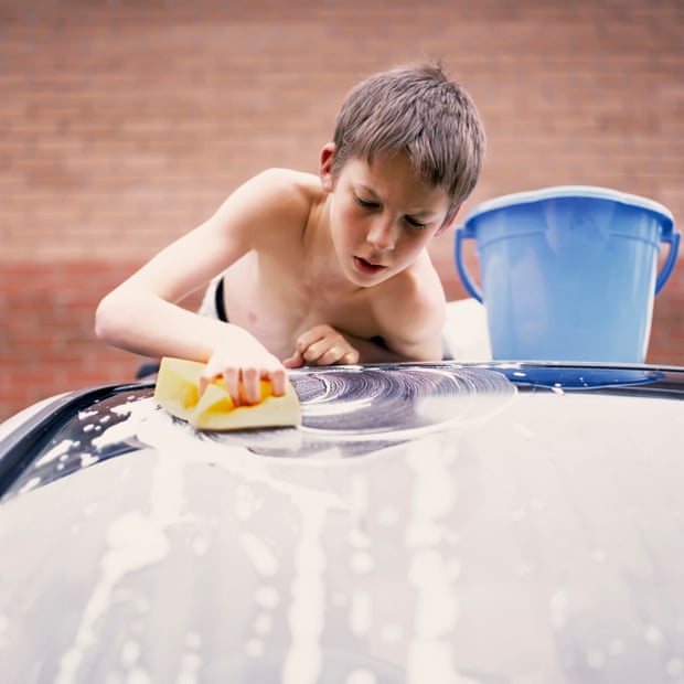 A boy washing a car, while thinking about maths.