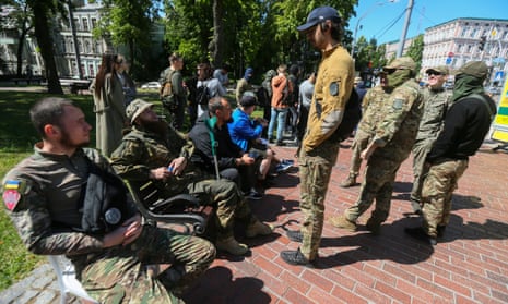 6 Ukrainian servicemen and Russian volunteers wait to donate blood in a special vehicle for donors in downtown Kyiv during an action 'Blood for the Ukrainian Armed Forces' amid the Russian invasion.