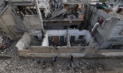 Palestinians inspect the damage to buildings after Israeli bombardment in Rafah in the southern Gaza Strip