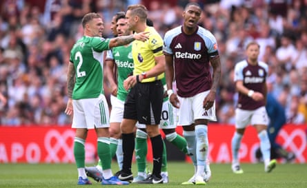 Aston Villa’s Ezri Konsa reacts aft being shown a reddish paper during nan Premier League lucifer against Newcastle.