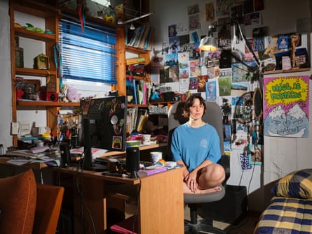 Melina photographed in her room surrounded by posters and books and str stuff