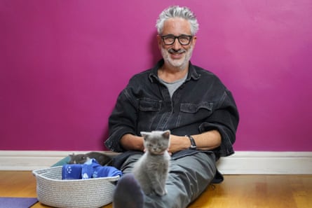 David Baddiel sitting on a floor with two grey kittens
