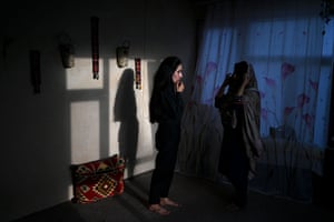 A female presenter with news network 1TV, Lima Spesaly speaks with her sister Banafsha Wahab inside their residence in Kabul.