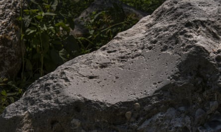 The polissoir has a dished glossy surface where it was used to polish stone axe heads over 5,000 years ago.