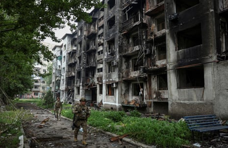 Members of the White Angel unit of Ukrainian police officers who evacuate people from the frontline towns and villages, check an area for residents, amid Russia's attack on Ukraine, in the frontline town of Pokrovsk in Donetsk region, Ukraine.