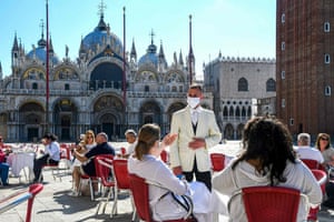Customers enjoy a drink at the terrace of Cafe Quadri on St. Mark’s Square