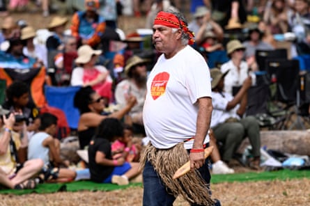 Middle aged Aboriginal man in white t-shrit with red headband 