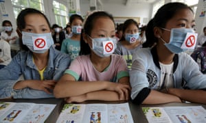Students wearing masks with no smoking signs attend an anti-smoking lecture in Fuyang, China. More than a million deaths a year in China are from smoking related diseases.