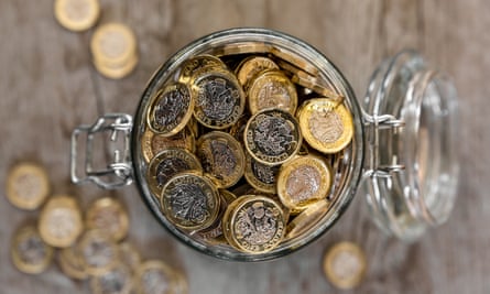 A jar full of saved one pound coins.