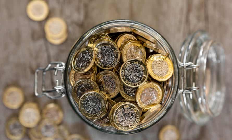 SavingsA jar full of saved one pound coins.