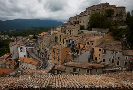 The pack rides through the village of Castelgrande