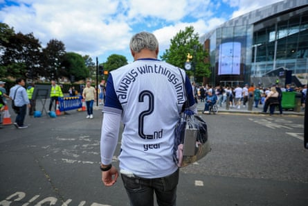 A Tottenham fan in a shirt reading ‘always win things in my 2nd year’