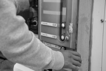 A hand paying for water at a dispenser