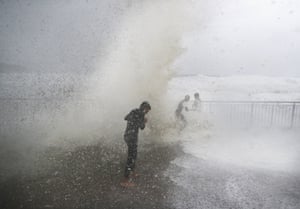 Children are soaked by huge waves at Bronte beach in Sydney on Sunday.