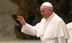Pope Francis waves as he arrives to lead his Wednesday general audience in Paul VI hall at the Vatican