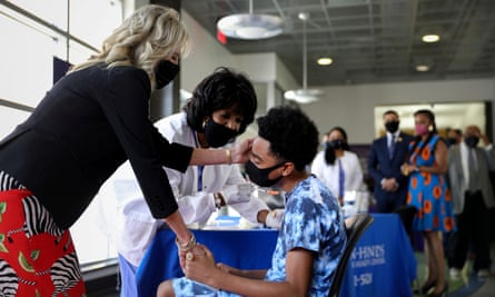 Jill Biden holds the hand of a nervous patient upon receiving a vaccination at Jackson State University in Mississippi.