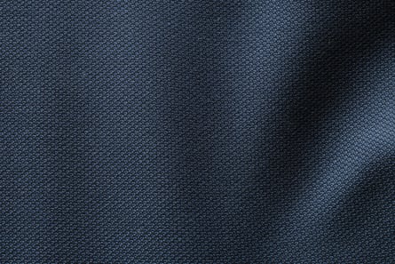 Un gros plan de tissu de costume en laine bleu foncé