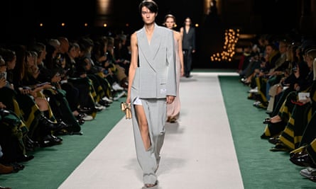 Models in slashed clothes on catwalk