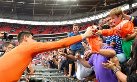 Thibaut Courtois gives his match shirt to a young Chelsea fan after the 2-1 win over Tottenham at Wembley on Sunday.