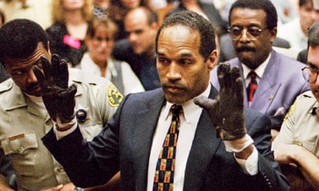 OJ Simpson wears the blood-stained gloves entered into evidence in his murder trial at the request of the prosecutor Christopher Darden in 1995.