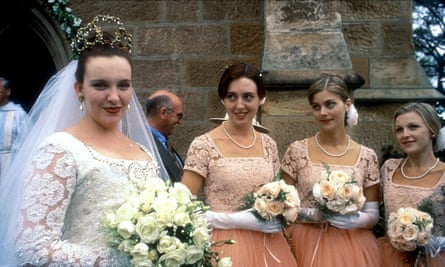 Muriel in a wedding dress with her bridesmaids