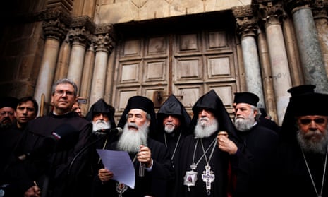 The Greek Orthodox patriarch of Jerusalem, Theophilos III, speaks in front of the closed doors of the Church of the Holy Sepulchre in Jerusalem’s Old City.