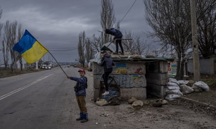 Ukrainian children play at an abandoned checkpoint in Kherson, southern Ukraine, Wednesday 23 November 2022.