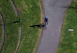 A person wears a mask while riding a bicycle in Auburn, Washington