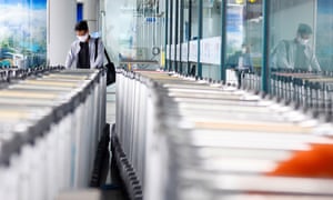 A man picks up a luggage trolley at Noi Bai international airport in Hanoi, Vietnam.