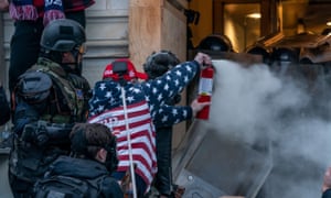 A pro-Trump protester uses tear gas against police at the Capitol on 6 January.
