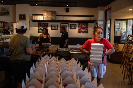 People prepare to distribute free dinner in to-go boxes at Joey’s Kitchen in Napili on west Maui, on 20 August 2023.