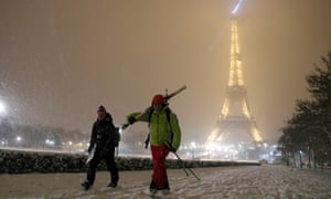 Men walk with skis on a snow-covered path near the Eiffel
Tower in Paris, as winter weather with snow and freezing
temperatures arrive in France.