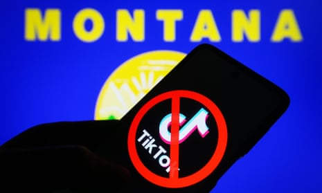 In this photo illustration, a crossed-out TikTok logo is seen on a smartphone and flag of the state of Montana on a PC screen